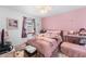 Bright, pink bedroom featuring a ceiling fan and a large window at 3191 S Holly Pl, Denver, CO 80222