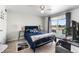 Cozy bedroom featuring a large bed, sliding glass doors, and ample natural light at 3191 S Holly Pl, Denver, CO 80222