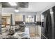 Well-lit kitchen featuring granite countertops, stainless steel appliances, and a gas stovetop at 3191 S Holly Pl, Denver, CO 80222