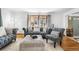 Inviting living room with ample seating, hardwood floors, and bright windows at 3191 S Holly Pl, Denver, CO 80222