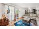 Bright living room with hardwood floors, sliding glass door and view of kitchen at 3191 S Holly Pl, Denver, CO 80222