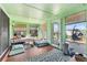 Bright sunroom with tiled floors, neutral decor, and multiple windows providing ample natural light at 3191 S Holly Pl, Denver, CO 80222