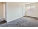 Inviting bedroom with neutral walls, plush carpeting, and a window for natural light at 8039 Wolff St # E, Westminster, CO 80031