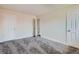 Bedroom featuring neutral walls, new carpet, and ample closet space for comfortable living at 8039 Wolff St # E, Westminster, CO 80031