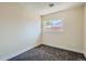 Cozy bedroom with neutral walls, plush carpeting, and a window for natural light at 8039 Wolff St # E, Westminster, CO 80031