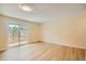 Bright, open bedroom with wood-look flooring and sliding glass door leading to outdoor patio at 8039 Wolff St # E, Westminster, CO 80031