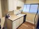 Kitchen features white cabinets, laminate countertops, and stainless steel sink, offering a functional workspace at 8039 Wolff St # E, Westminster, CO 80031