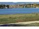 Expansive lake view surrounded by trees and distant city buildings on a bright sunny day at 8039 Wolff St # E, Westminster, CO 80031