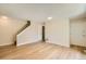 Bright living room features wood-look flooring, neutral paint, and convenient access to stairs and doors at 8039 Wolff St # E, Westminster, CO 80031