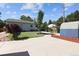 View of lawn, storage sheds, patio, landscaping, and wood fence enclosing backyard at 1455 W Alaska Pl, Denver, CO 80223