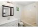 Bathroom featuring a vanity, mirror, toilet and shower/tub combo at 1455 W Alaska Pl, Denver, CO 80223