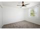 Cozy bedroom with carpet, ceiling fan, and a window offering natural light at 1455 W Alaska Pl, Denver, CO 80223