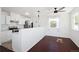 Eat-in kitchen with modern appliances, with an adjacent dining area with wood floors at 1455 W Alaska Pl, Denver, CO 80223