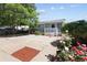 Exterior of home with a covered porch, landscaping and paved driveway at 1455 W Alaska Pl, Denver, CO 80223