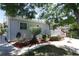 A well-maintained yard surrounds the light blue home, showcasing neat landscaping at 1455 W Alaska Pl, Denver, CO 80223