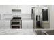 Modern kitchen featuring stainless steel appliances and double oven at 1455 W Alaska Pl, Denver, CO 80223