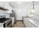 A modern kitchen with white cabinets, stainless steel appliances and marble countertops at 1455 W Alaska Pl, Denver, CO 80223