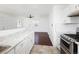 Bright kitchen with modern appliances, white cabinets, and dark-wood flooring at 1455 W Alaska Pl, Denver, CO 80223