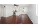 Bright living room with hardwood floors, open to an updated kitchen with stainless appliances at 1455 W Alaska Pl, Denver, CO 80223