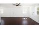Spacious living room with hardwood floors, natural light, and two entry doors at 1455 W Alaska Pl, Denver, CO 80223