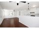 Open-concept kitchen and living area with modern finishes and hardwood floors at 1455 W Alaska Pl, Denver, CO 80223