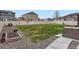 Expansive backyard features a lush lawn, garden bed, and patio seating area, perfect for outdoor enjoyment at 12815 Randles Ave, Parker, CO 80134