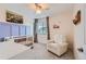 A cozy Bedroom features a crib, comfortable chair, and charming decor for a soothing environment at 12815 Randles Ave, Parker, CO 80134