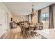 Open concept dining and living room with hardwood floors and modern chandelier over the dining table at 12815 Randles Ave, Parker, CO 80134