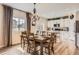 Elegant dining area adjacent to a modern kitchen, bathed in natural light from a nearby window at 12815 Randles Ave, Parker, CO 80134