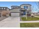 Charming two-story home featuring a two-car garage, well-maintained lawn and traditional design at 12815 Randles Ave, Parker, CO 80134