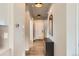 Bright hallway featuring wood-like flooring, modern light fixtures, and access to multiple rooms at 12815 Randles Ave, Parker, CO 80134