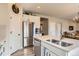 Spacious kitchen featuring stainless steel appliances, white cabinets, and a central island with a sink at 12815 Randles Ave, Parker, CO 80134