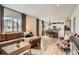 Bright living area with open floor plan leading to the kitchen and dining area with hardwood floors at 12815 Randles Ave, Parker, CO 80134