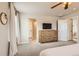 Spacious primary bedroom with a dresser and access to the bathroom and closet at 12815 Randles Ave, Parker, CO 80134