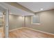 Finished basement area with a window, neutral paint and beautiful hardwood floors at 3232 Cimarron Pl, Superior, CO 80027