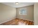 Neutral bedroom featuring wood floors, a window and base molding at 3232 Cimarron Pl, Superior, CO 80027