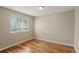 Bedroom featuring wood floors, a window and base molding at 3232 Cimarron Pl, Superior, CO 80027