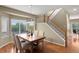 Bright dining area featuring a wooden staircase and a view of the outdoors at 3232 Cimarron Pl, Superior, CO 80027