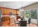 Eat-in kitchen features stainless appliances, wood cabinets, and sliding door access to deck at 3232 Cimarron Pl, Superior, CO 80027