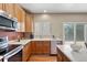 Bright kitchen features stainless steel appliances, white countertops and a slider to the backyard at 3232 Cimarron Pl, Superior, CO 80027