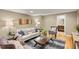 Comfortable living room with a plush sofa, stylish decor, and a glimpse into the bathroom at 3232 Cimarron Pl, Superior, CO 80027