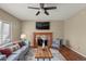 Elegant living room featuring a fireplace, mounted TV, and neutral color palette at 3232 Cimarron Pl, Superior, CO 80027