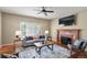 Bright living room featuring a fireplace, ceiling fan, and comfortable seating arrangement at 3232 Cimarron Pl, Superior, CO 80027