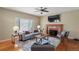 Warm living room with a cozy fireplace, hardwood floors, and comfortable seating at 3232 Cimarron Pl, Superior, CO 80027