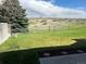 Fenced backyard with green grass and views of open space at 11323 E Cimmarron Dr, Englewood, CO 80111
