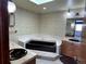 Bathroom with black tub, sinks and beige floral wallpaper at 11323 E Cimmarron Dr, Englewood, CO 80111