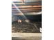View of a crawlspace with visible beams, insulation, and floor covering at 11323 E Cimmarron Dr, Englewood, CO 80111