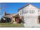 Charming two-story home featuring a brick facade and well-maintained landscaping at 11323 E Cimmarron Dr, Englewood, CO 80111