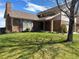 Attractive brick home featuring a manicured lawn and mature trees at 11323 E Cimmarron Dr, Englewood, CO 80111