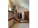 Inviting foyer boasts a grand staircase, wood accents, and warm lighting at 11323 E Cimmarron Dr, Englewood, CO 80111